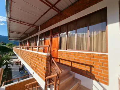 a brick building with stairs and windows on it at Pampa Bella Lodge in La Merced