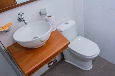 a white bathroom with a sink and a toilet at Apartamento Altoandino in Ayacucho