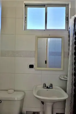 a bathroom with a sink and a mirror and a toilet at Suite 1 Fila Vista Bahía Paracas- La Velas 601 T1 in Paracas