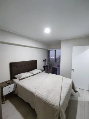 a bedroom with a large bed and a window at Epiqe Manuel Olguin 600 in Lima