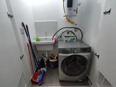 a laundry room with a washing machine and a sink at Epiqe Manuel Olguin 600 in Lima