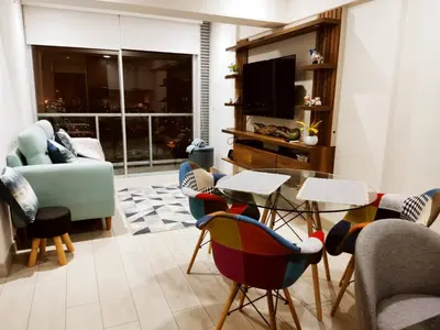 a living room with a table and chairs at Epiqe Manuel Olguin 600 in Lima
