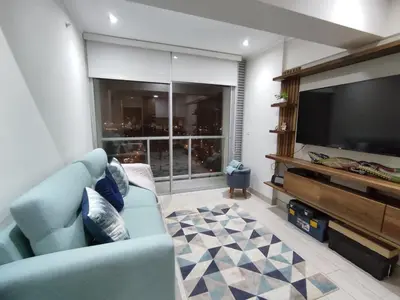 a living room with a blue couch and a flat screen tv at Epiqe Manuel Olguin 600 in Lima
