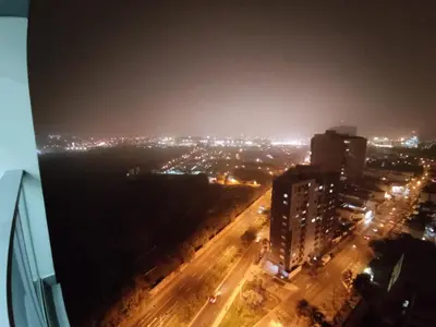 a view of a city at night with lights at Epiqe Manuel Olguin 600 in Lima