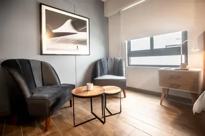 a living room with two chairs and a table at SoHo by Wynwood House in Lima