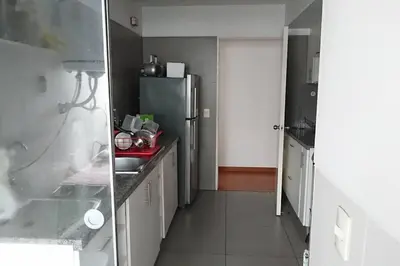 a kitchen with a sink and a refrigerator at Elegante Flat en inmejorable ubicación - San Isidro in Lima