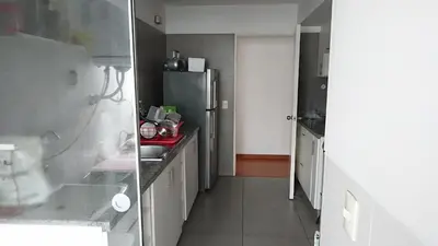 a kitchen with a sink and a refrigerator at Elegante Flat en inmejorable ubicación - San Isidro in Lima