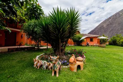 a garden with a group of dogs and a tree at LILIUM VALLEY in Ollantaytambo