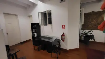 a room with a table and chairs in a room at La Casona Hospedaje in Lima