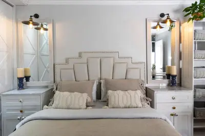 a bedroom with a large white bed with two mirrors at Casa Ramos Salamanca - Airport pick up and drop off service - Homestay in Lima