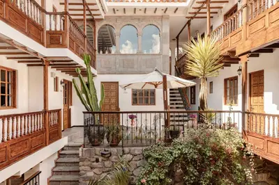 a courtyard of a house with stairs and plants at Andenes in Cusco