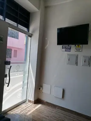 a room with a flat screen tv on a wall at Hostal Pacífico Huánuco in Huánuco