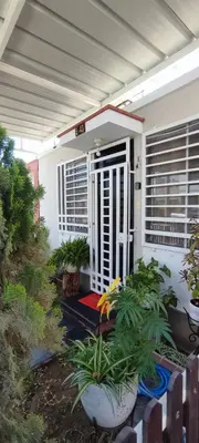 a house with a porch with some plants in it at Casa Club Vacacional in Ica