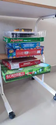 a stack of childrens books on a shelf at Casa Club Vacacional in Ica
