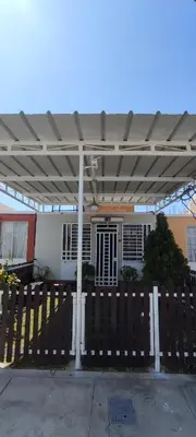 a building with awning over a wooden fence at Casa Club Vacacional in Ica