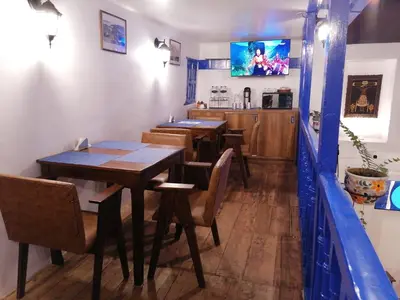 a dining room with wooden tables and chairs at El Ave Azul Boutique Hotel Cusco in Cusco