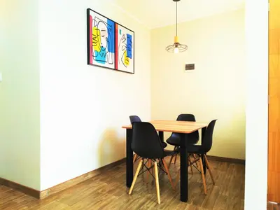 a dining room with a table and chairs at Departamento Hermoso en Residencial - Huacachina in Ica