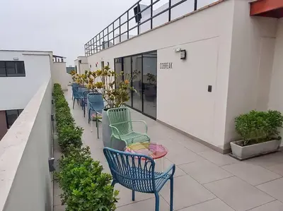 a row of blue chairs sitting on a balcony at Apartamento estreno céntrico y moderno in Lima