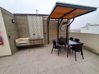 a balcony with a table and chairs and a bed at Apartamento estreno céntrico y moderno in Lima