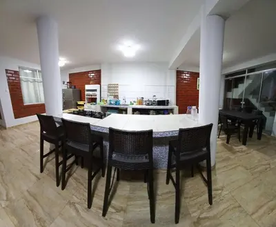 a kitchen with a table and chairs in a room at CASA PLAYA REFUGIO AZUL in Cerro Azul