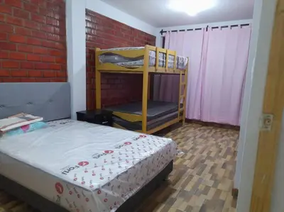 a bedroom with a bunk bed and a brick wall at CASA PLAYA REFUGIO AZUL in Cerro Azul