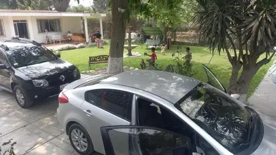 a silver car parked next to a tree in a yard at casa campestre marina in Chaclacayo
