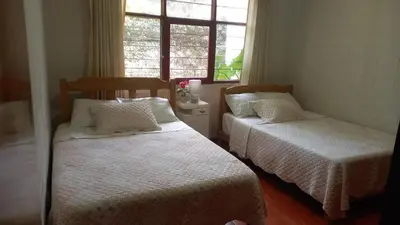 a bedroom with two beds and a window at casa campestre marina in Chaclacayo