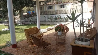 a patio with chairs and a table with a potted plant at casa campestre marina in Chaclacayo