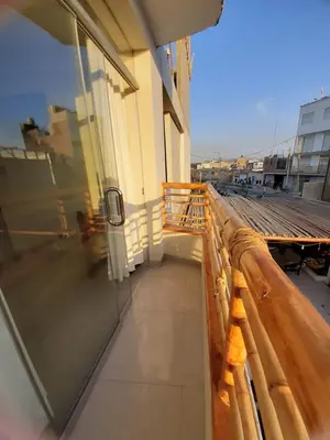 a balcony with a glass door on a building at Hostel Willys House in Paracas