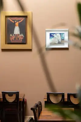a room with two pictures on the wall and chairs at Mamasara Cusco in Cusco