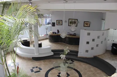 a large room with a table and some plants at Embassy Beach in Pisco