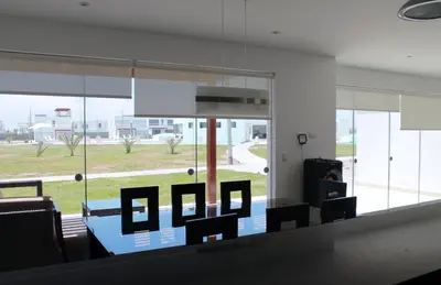 a living room with chairs and a large window at Casa 33 Sotavento Paracas in Paracas
