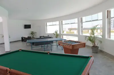 a pool table in a large room with windows at Casa 33 Sotavento Paracas in Paracas