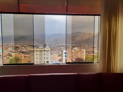 a view of a city from a window at WAYRA APART HOTEL in Cusco
