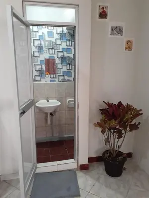 a bathroom with a shower and a sink and a sink at WAYRA APART HOTEL in Cusco