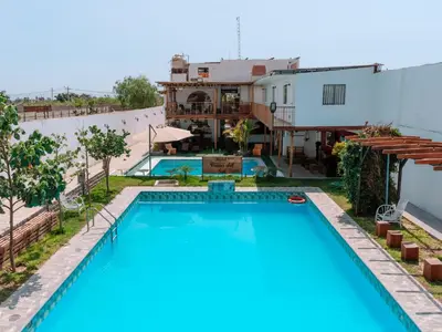 a view of a swimming pool and a house at Hotel Viñas del Sol Eterno in Chincha Alta