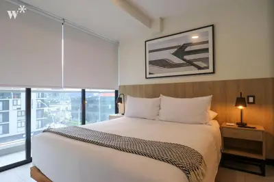 a bedroom with a white bed and a large window at Navarrete by Wynwood House in Lima