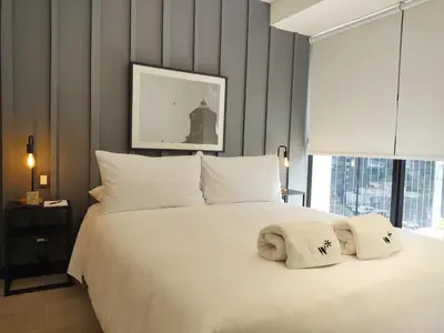 a large white bed with two pillows on it at Navarrete by Wynwood House in Lima