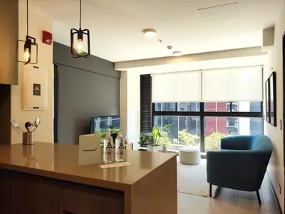 a living room with a desk and a blue chair at Navarrete by Wynwood House in Lima