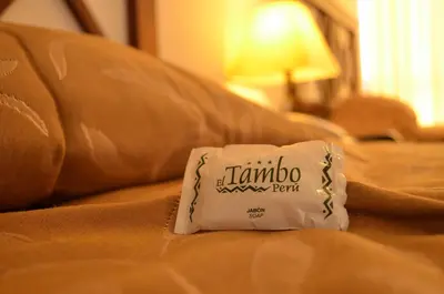 a white pillow on a couch with a couch at El Tambo 1 in Lima