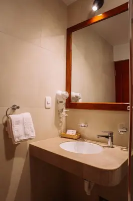 a bathroom with a sink and a mirror at Tikawasi ollanta 2 incluye transporte o recojo a la estacion de tren in Ollantaytambo