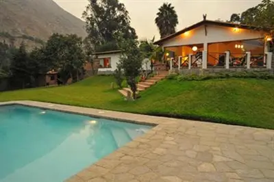 a house with a swimming pool in front of a house at Casa El Palto in Santa Eulalia