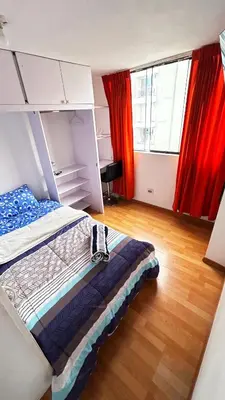 a bedroom with a bed and red curtains at IV Hermosa Habitacion Privada en Miraflores City in Lima