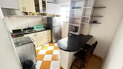 a small kitchen with a counter and a refrigerator at IV Hermosa Habitacion Privada en Miraflores City in Lima