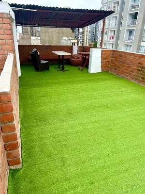 a patio with green grass and a table on a building at IV Hermosa Habitacion Privada en Miraflores City in Lima
