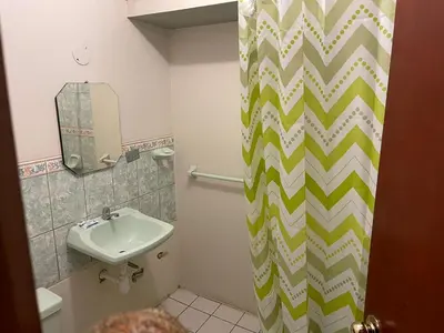 a bathroom with a sink and a shower curtain at Entre Cava y Cata in Ica