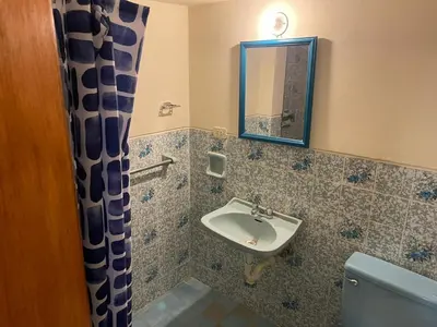 a bathroom with a sink and a toilet and a mirror at Entre Cava y Cata in Ica