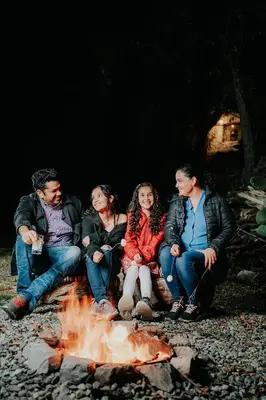 a group of people sitting around a fire at Hotel Vallehermoso in Cotahuasi