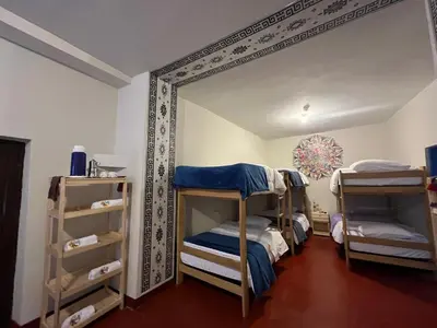 a room with two bunk beds and a mirror at The Sleepy Mouse in Cusco