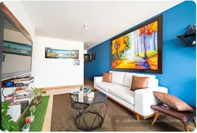 a living room with a white couch and a painting at Precioso cuarto dentro de un apartamento centrico compartido in Lima